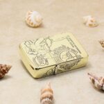 KZ161 five-side engraved brass Zippo lighter on a sandy display