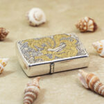 KZ208 silver-tone Zippo Armor lighter with gold-tone accents, angled view