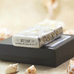Mythological Figures Zippo Armor lighter displayed with its black Zippo box