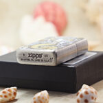 Mermaid Zippo Armor lighter displayed with its black Zippo box