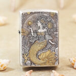 Silver-tone Mermaid Zippo Armor lighter with engraved ocean-inspired artwork