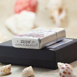 Red Spider Lily Zippo Armor lighter displayed with its black Zippo box