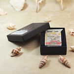 Open Red Spider Lily Zippo Armor lighter presented beside the original box