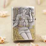 Close-up of the motorbike-themed female engraving on the Zippo Armor lighter