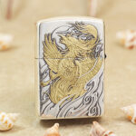 Close-up of the phoenix, cloud and floral engraving on the Zippo Armor lighter