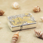 Angled view of the Phoenix Zippo Armor lighter with gold-tone details