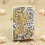 Silver-tone Zippo Armor lighter with an engraved gold-accented phoenix