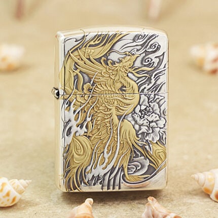 Silver-tone Zippo Armor lighter with an engraved gold-accented phoenix