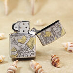 Open silver-tone Zippo Armor lighter showing the reverse decorative engraving