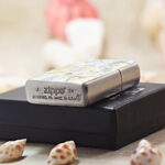 Beach Beauty Zippo Armor lighter displayed with its black Zippo box