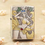 Silver-tone Beach Beauty Zippo Armor lighter with engraved figure and gold-tone accents
