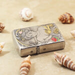 Angled view of the Scent of a Woman Zippo Armor lighter with gold-tone details