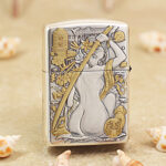 Close-up of the geisha and dragon engraving on the silver-tone Zippo Armor lighter