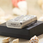 Tang Dynasty silver-and-gold Zippo Armor lighter displayed with Zippo packaging