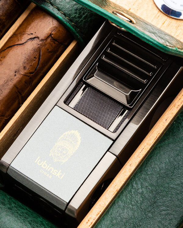 CH-022-02 Close-up of a Lubinski cigar accessory in a green leather cigar case with cigars beside it.