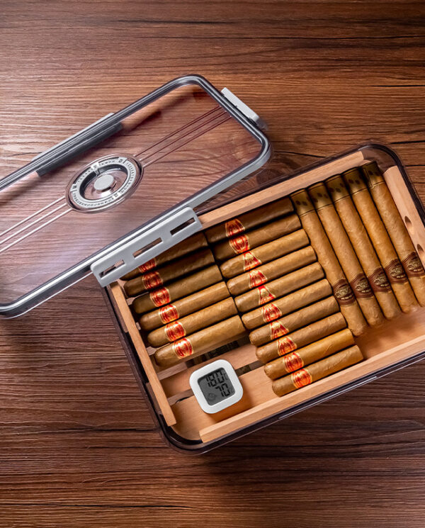 CH001-01 Open glass-trosted humidor lid hinged to the side, showing neatly arranged cigars inside next to a small digital hygrometer on a wooden surface.
