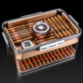 Open glass-top cigar humidor with neatly arranged cigars and a built-in hygrometer display inside the box.