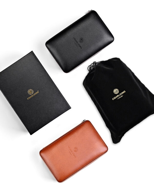 Set of leather wallets in black and tan with a black drawstring pouch and a black box on a white background, showing brand embossing on each item.