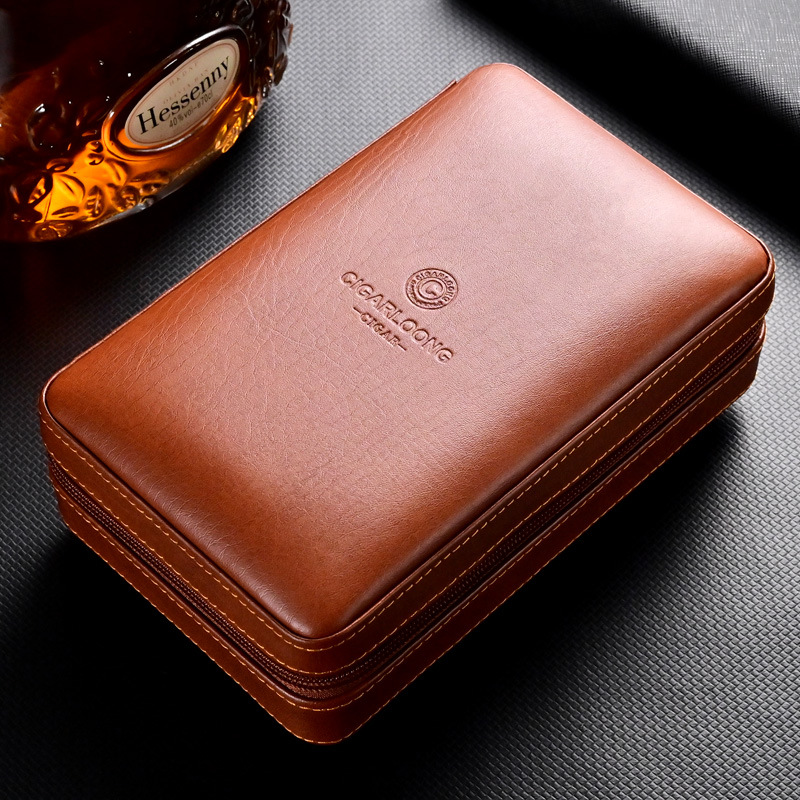Brown leather zippered case with stitching and embossed brand on a dark textured surface; whiskey bottle visible in the background.
