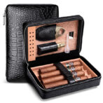 Opened black textured leather cigar case showing cigars and accessories arranged in a wooden interior tray.
