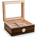 Open wooden cigar humidor with divided inner trays and a brass hygrometer on the front edge.