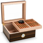 Wooden cigar humidor with lid open, showing two trays of cigars and a humidifier on top, plus a built-in hygrometer on the front panel
