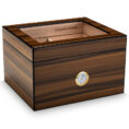 Wooden cigar humidor with a glass top window and a gold-rimmed hygrometer on the front, used to store cigars.