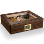 Wooden cigar humidor with a glass top, containing cigars and a digital humidity display on the front panel.