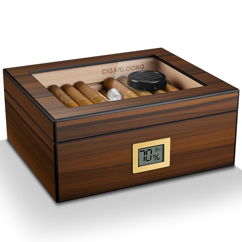 Wooden cigar humidor with glass top, cigars inside and a digital humidity/temperature display on the front.