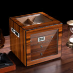 Wooden cigar humidor with glass front and digital humidity display showing 70%.
