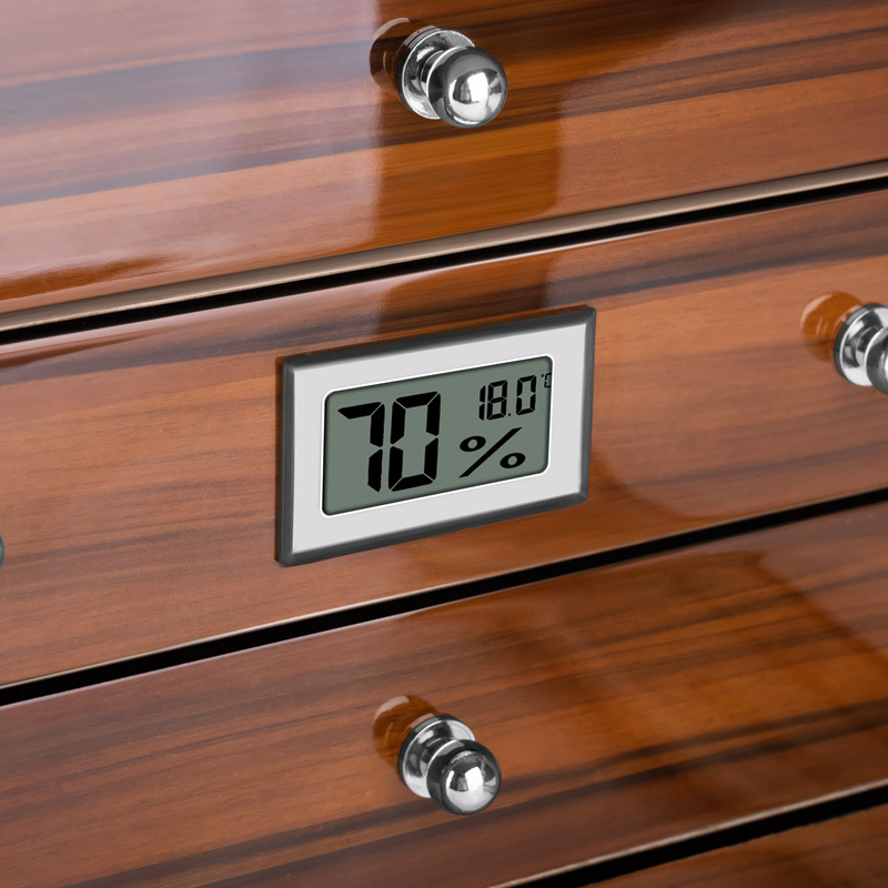 Digital humidity and temperature display on a wooden dresser showing 70% humidity and 18.0°C (built-in monitor).