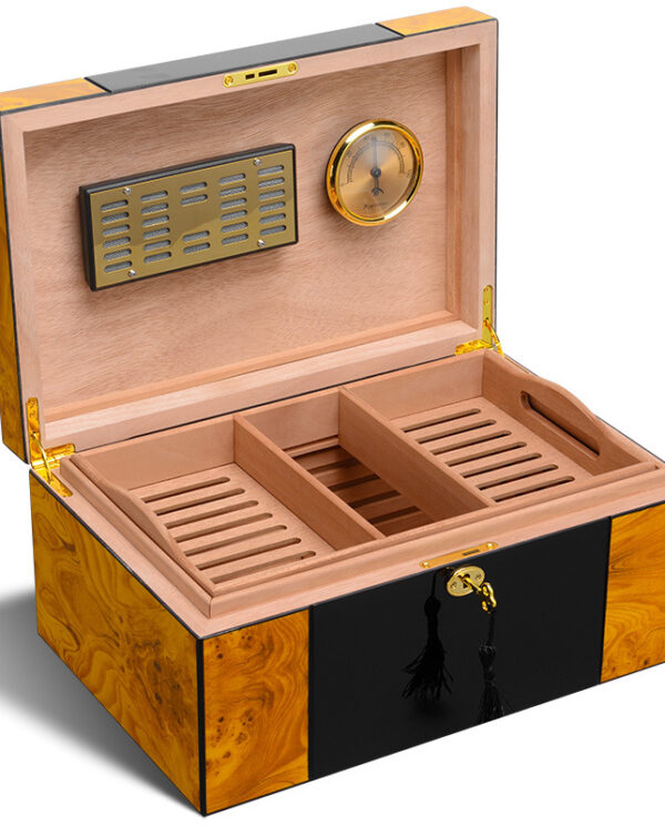 Open wooden cigar humidor with three divided trays, brass hinges, and a brass hygrometer on the lid (humidor interior shown).