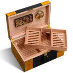 Open wooden cigar humidor showing a two-tier sliding tray, cedar lining, and a built-in hygrometer with brass hardware.