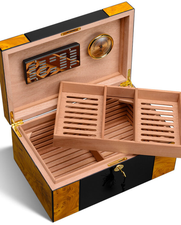 Open wooden cigar humidor showing a two-tier sliding tray, cedar lining, and a built-in hygrometer with brass hardware.