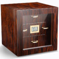 Wooden safe with glass front and digital display, gold handles, standing on a white surface