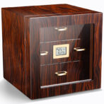 Wooden safe with glass front and digital display, gold handles, standing on a white surface
