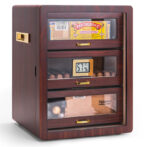 Wooden cigar humidor with glass-front drawers displaying Partagás cigars, a digital hygrometer showing 51% humidity, and a Trinidad box in the bottom drawer.