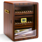 Wooden cigar humidor with cigars on shelves and a digital hygrometer showing 70% humidity (bottom drawer visible).