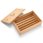 Open wooden cigar box with five cigars inside, neatly arranged in a row.