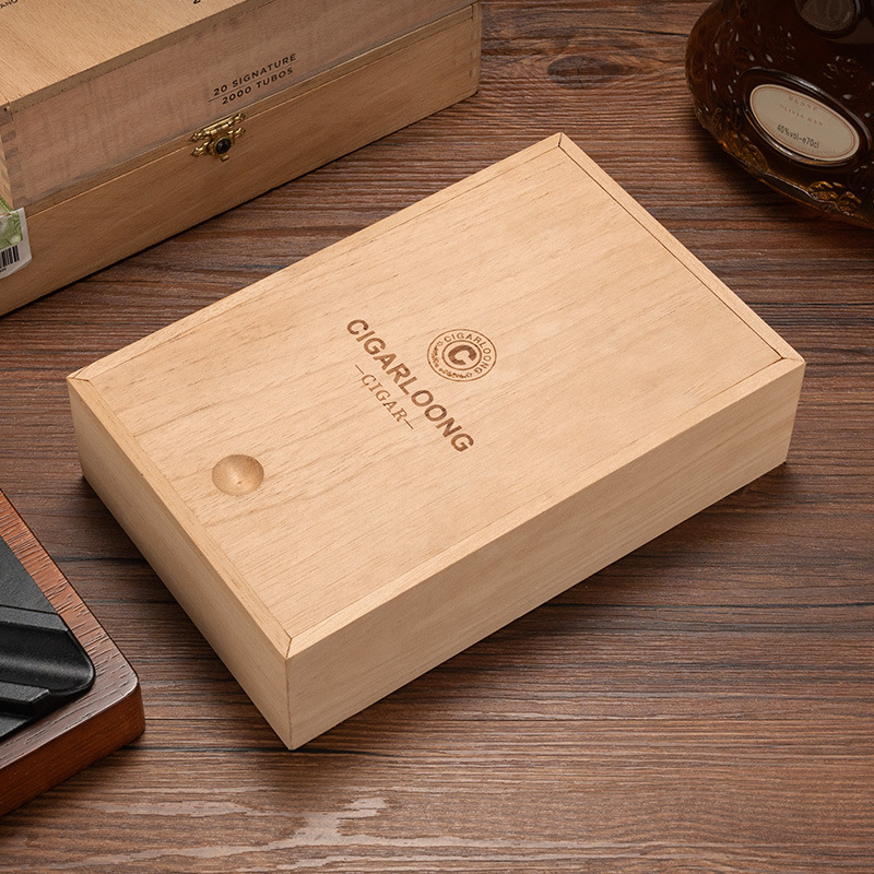 Light wooden cigar box with brand logo on a wooden table surface.