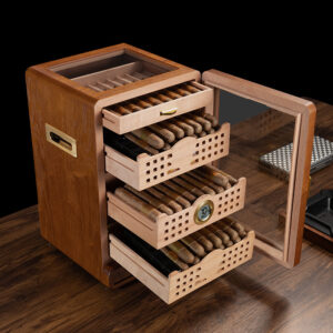 Open wooden cigar humidor with four sliding trays of cigars, a built-in hygrometer, and a glass door on a wooden table