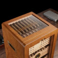 Wooden cigar humidor with a glass lid showing neatly arranged cigars inside.