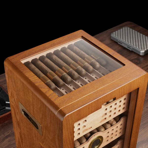 Wooden cigar humidor with a glass lid showing neatly arranged cigars inside.
