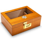 Wooden humidor with a glass top, brass lock, and humidity gauge for storing cigars.