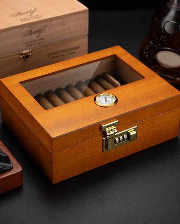 Wooden cigar humidor with a transparent lid showing cigars inside and a small humidity gauge on top.