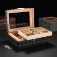 Open luxury cigar humidor with a slide-out tray of cigars and a mirrored lid revealing a leather-quilted exterior.