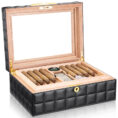 Open wooden humidor with black quilted exterior, cigars neatly arranged and a humidity gauge visible inside the lid.