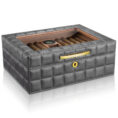 Gray quilted leather cigar humidor with glass lid and cigars inside.