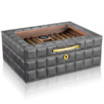 Gray quilted leather cigar humidor with glass lid and cigars inside.