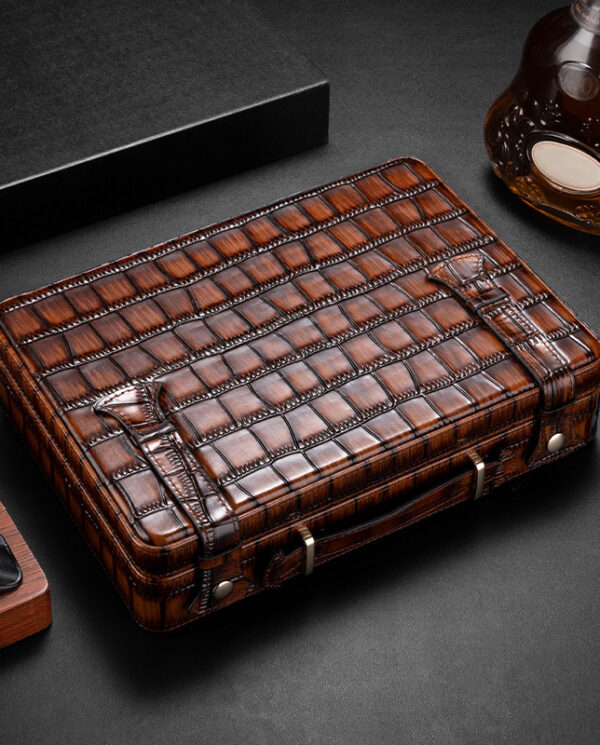 CH015 Brown crocodile-embossed leather wallet with a strap and metal fasteners on a dark surface.